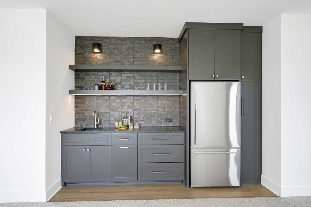 Close up view of a built in bar with a sink and a refrigerator. 3761 William Way Independence Mn 55359 105