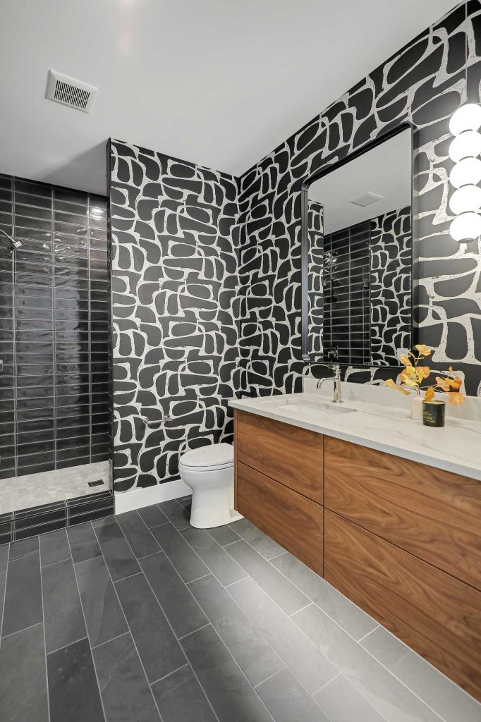 Bathroom with black and white designed wallpaper, black tile floor. 3761 William Way Independence Mn 55359 115
