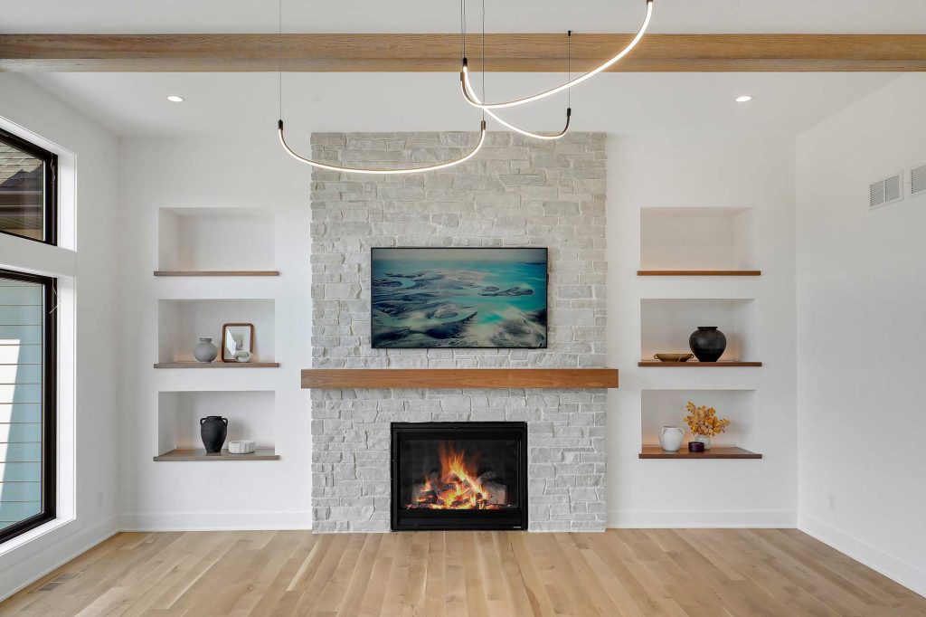 view of a built in Fireplace with built in shelves next to it and big windows. 3761 William Way Independence Mn 55359
