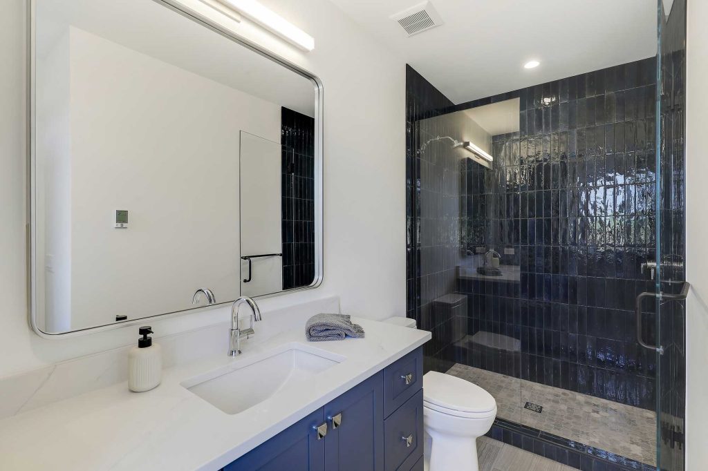 Bathroom with blue accents. Blue cabinet and tile in the shower. 3761 William Way Independence Mn 55359 121