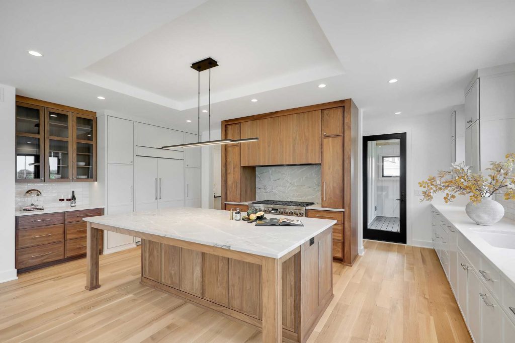 Side view of a built in shelf, big table and big windows in a kitchen/dining room. 3761 William Way Independence Mn 55359 24