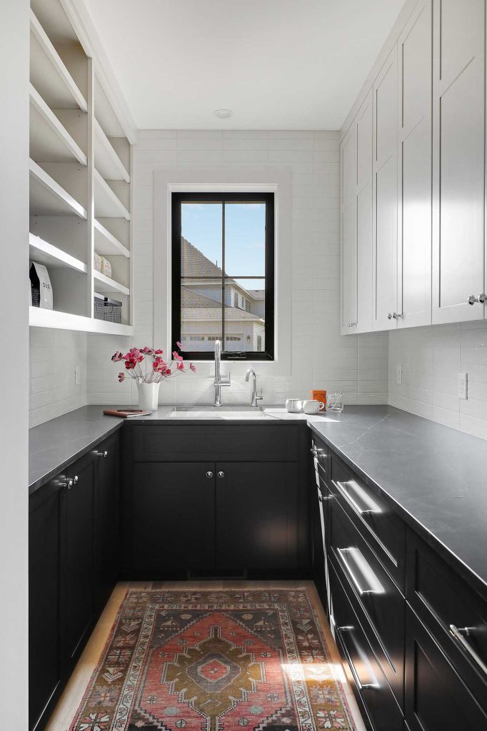 Small nook with black counters, black drawers and a sink and white cabinets above. 3761 William Way Independence Mn 55359 51
