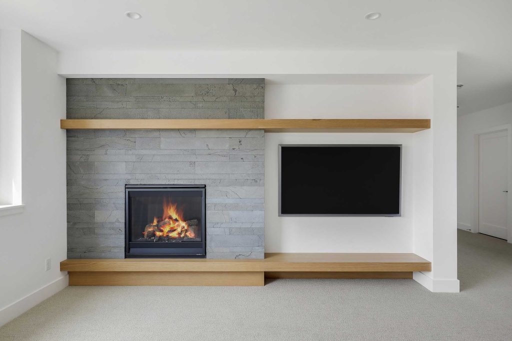 Close up view of a built in fireplace and a big screen tv on the wall next to it. 3761 William Way Independence Mn 55359 99
